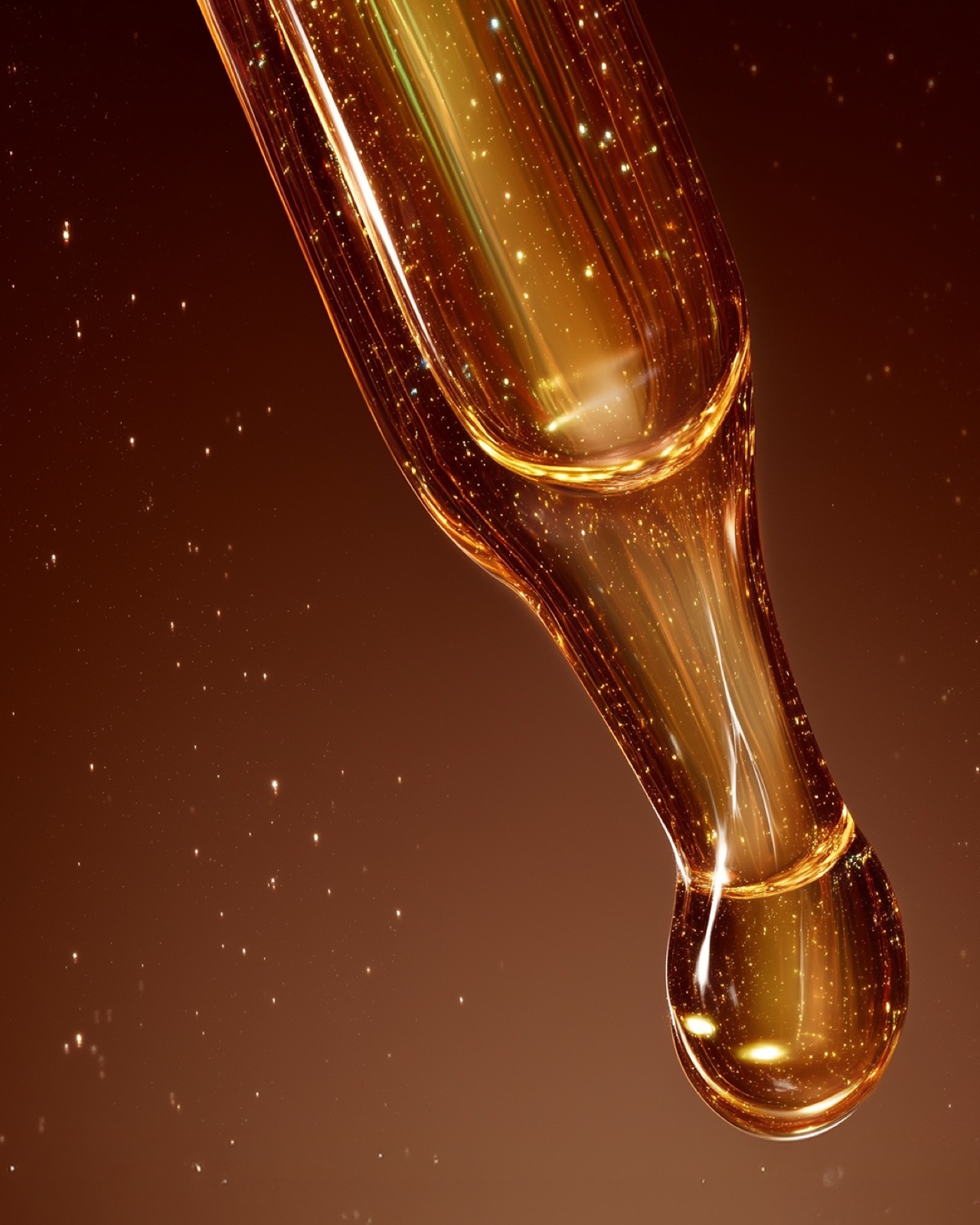A golden serum drop forming at a dropper tip, light treated as a living substance