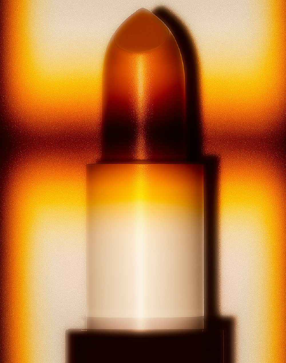 A lipstick bullet lit in warm amber light, an example of Highlight London visual DNA