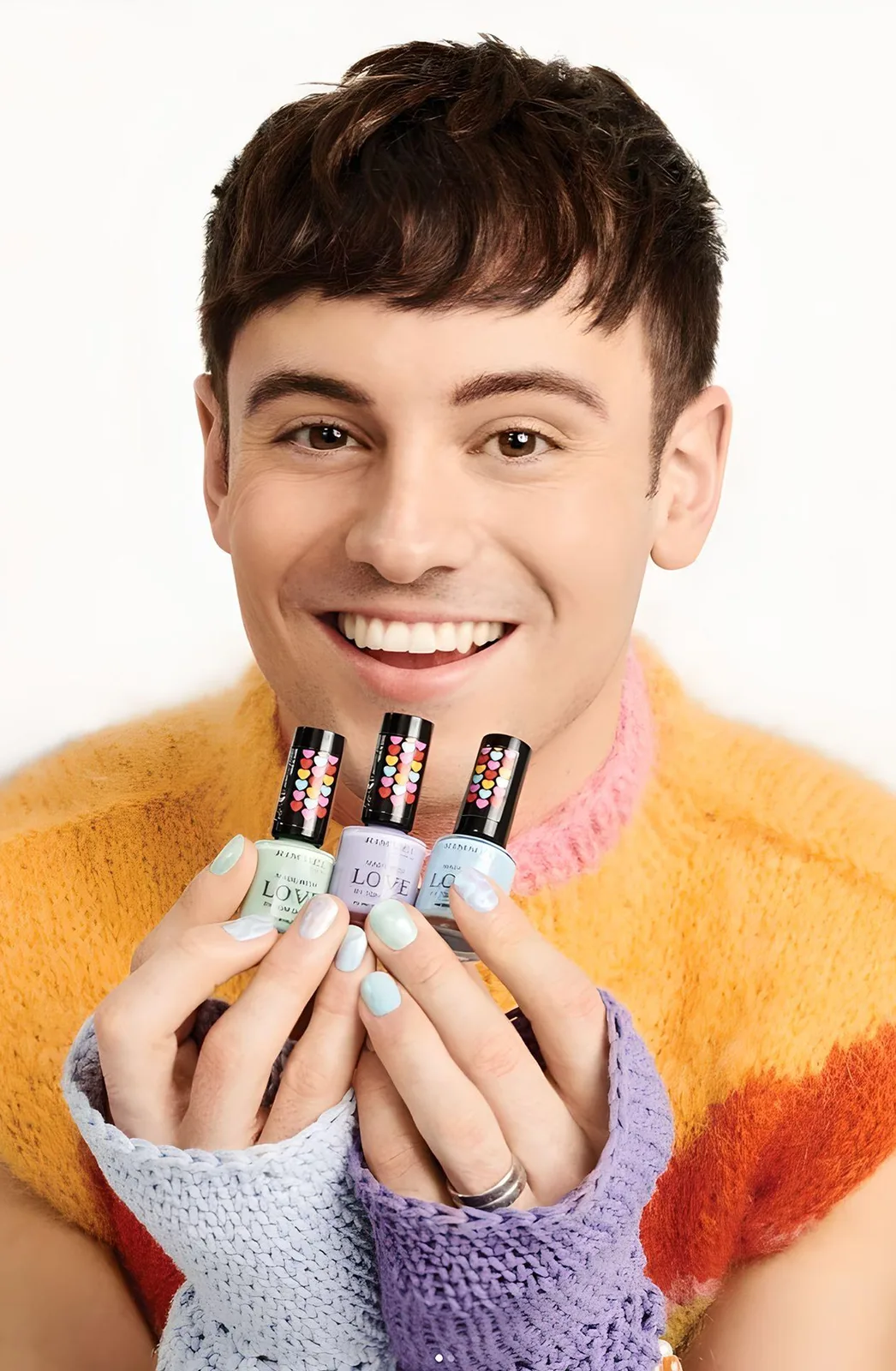 Tom Daley holding the Made with Love nail collection for Rimmel, packaging by Highlight London